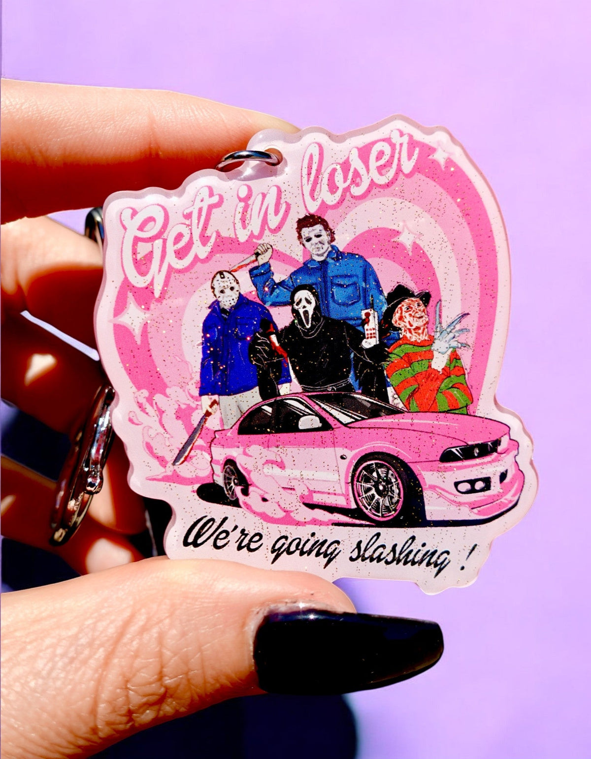 Funny Pink Halloween keychain charm with car and cartoon figures, pink glitter background
