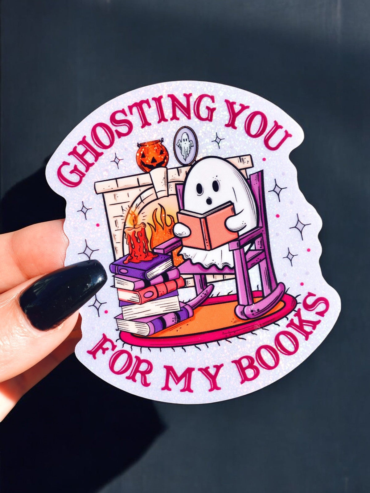 Funny Ghosting books sticker: cartoon ghost by stacked books with text 'GHOSTING YOU FOR MY BOOKS'.