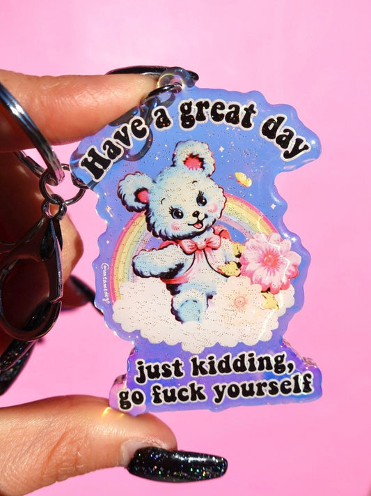Funny Rainbow glitter keychain with cute white bear and smiling text on blue heart-shaped charm