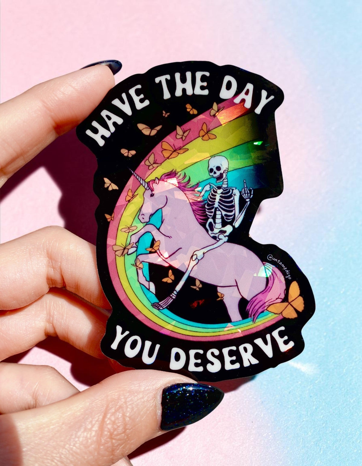 Funny Have the Day You Deserve sticker, black outline with rainbow unicorn and skeleton art