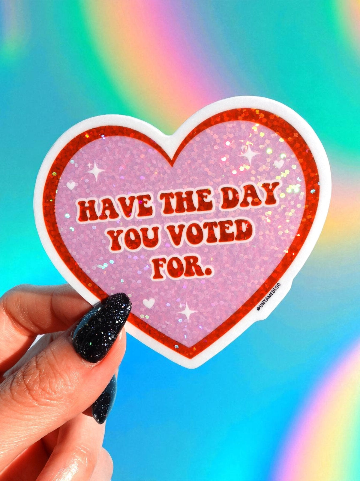 Funny Heart-shaped vinyl sticker with glitter purple heart, white outline, reads “Have the day you voted for.”