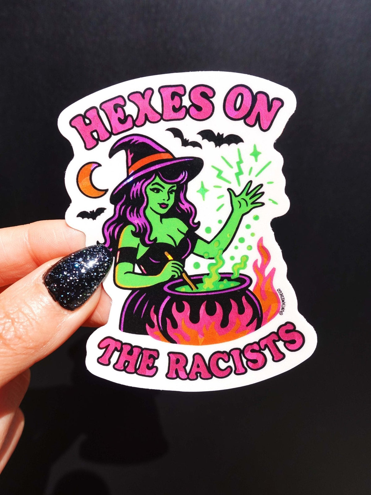 Funny Halloween vinyl sticker with green witch and cauldron, text HEXES ON THE RACISTS