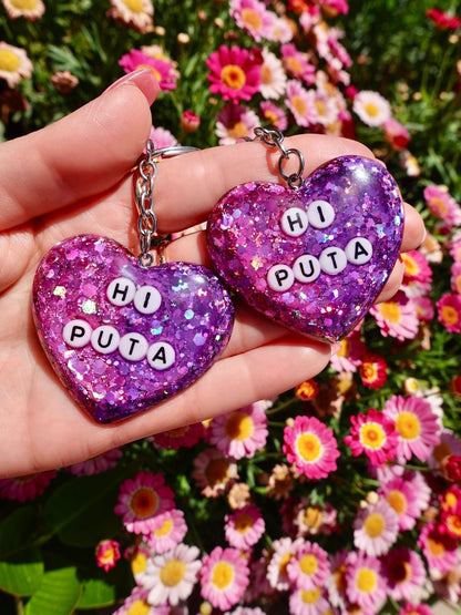 Funny Pair of purple glitter heart keychains with metal rings and “HI PUTA” letters