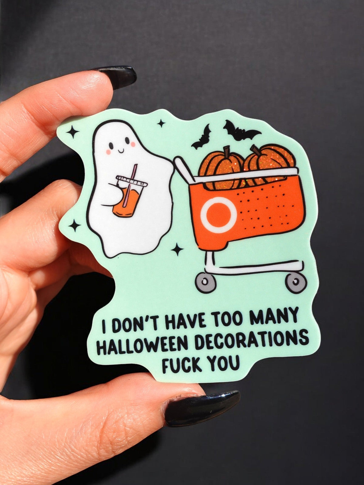 Funny Halloween ghost sticker in hand with mint border, orange jack-o-lantern cauldron, bats, 'FUCK YOU'