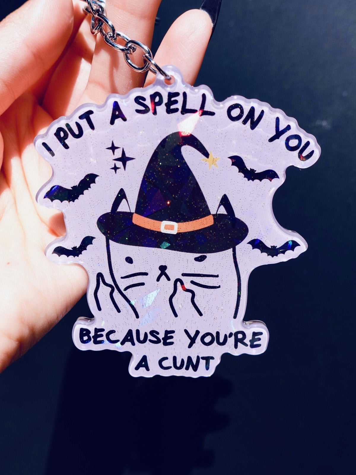 Funny Holographic keychain with witch hat and bats, blue starry design and black text