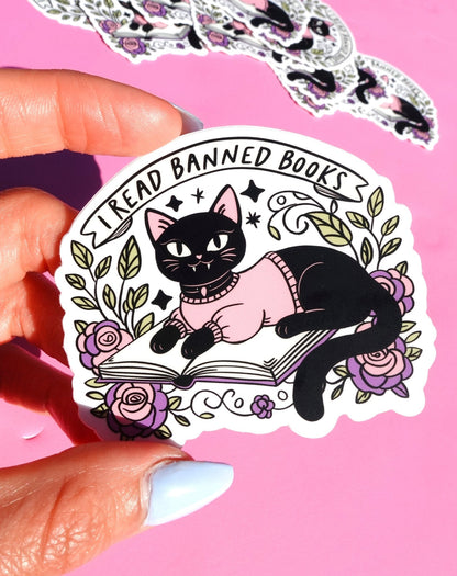 Funny Cat reading open book sticker with floral wreath and 'I Read Banned Books' text