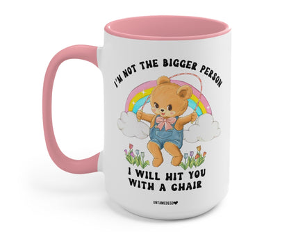 Funny "I'm Not The Bigger Person I Will Hit You With A Chair" — Pink-handled ceramic mug with angel bear rainbow graphic and quote text