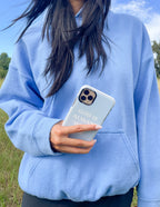 Christian iPhone Case with the message 'God is Always' held by a person in a blue hoodie