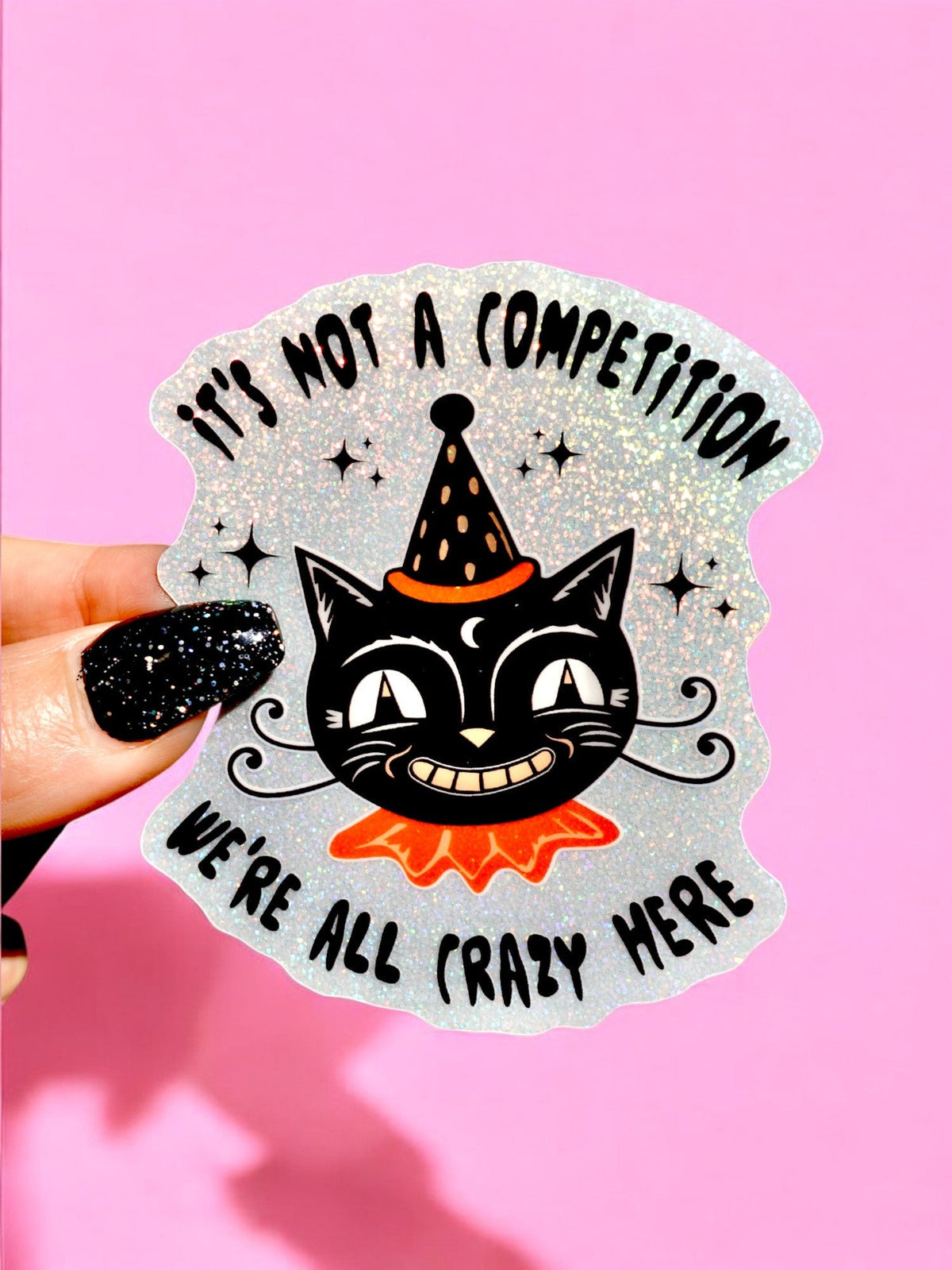 Funny Glitter cat wizard sticker with "It's Not A Competition" text and star accents