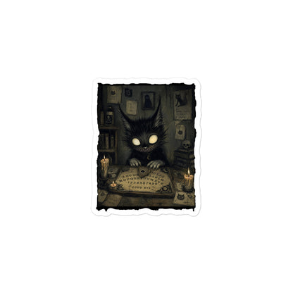 3 x 3 inch 'Free Readings' goth sticker featuring a wide-eyed black cat creature at a Ouija board surrounded by candles