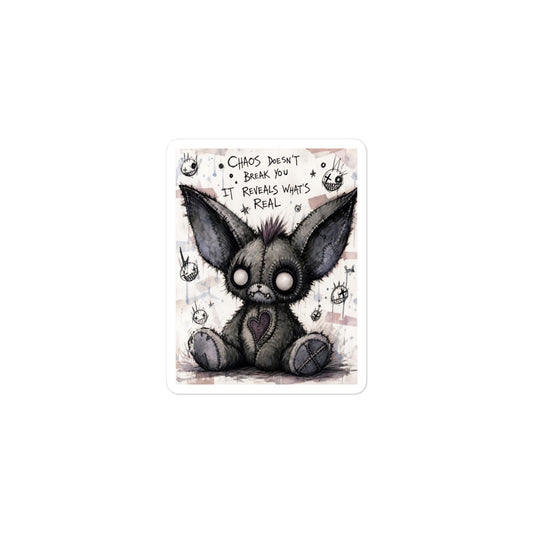3 x 3 inch 'Chaos' goth sticker featuring a stitched gray big-eared creature with button eyes, with the words "Chaos doesn't break you, it reveals what's real"