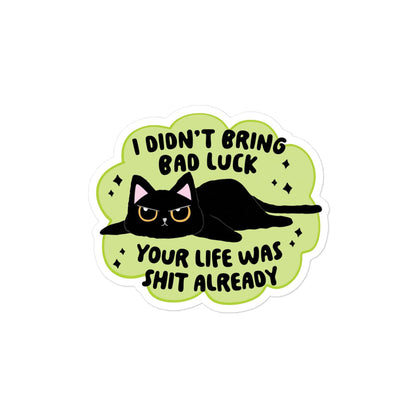 Funny Bubble-free sticker with black cat lying down on neon-green speech bubble, 'BAD LUCK'