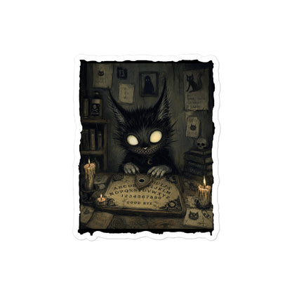 4 x 4 inch 'Free Readings' goth sticker featuring a wide-eyed black cat creature at a Ouija board surrounded by candles