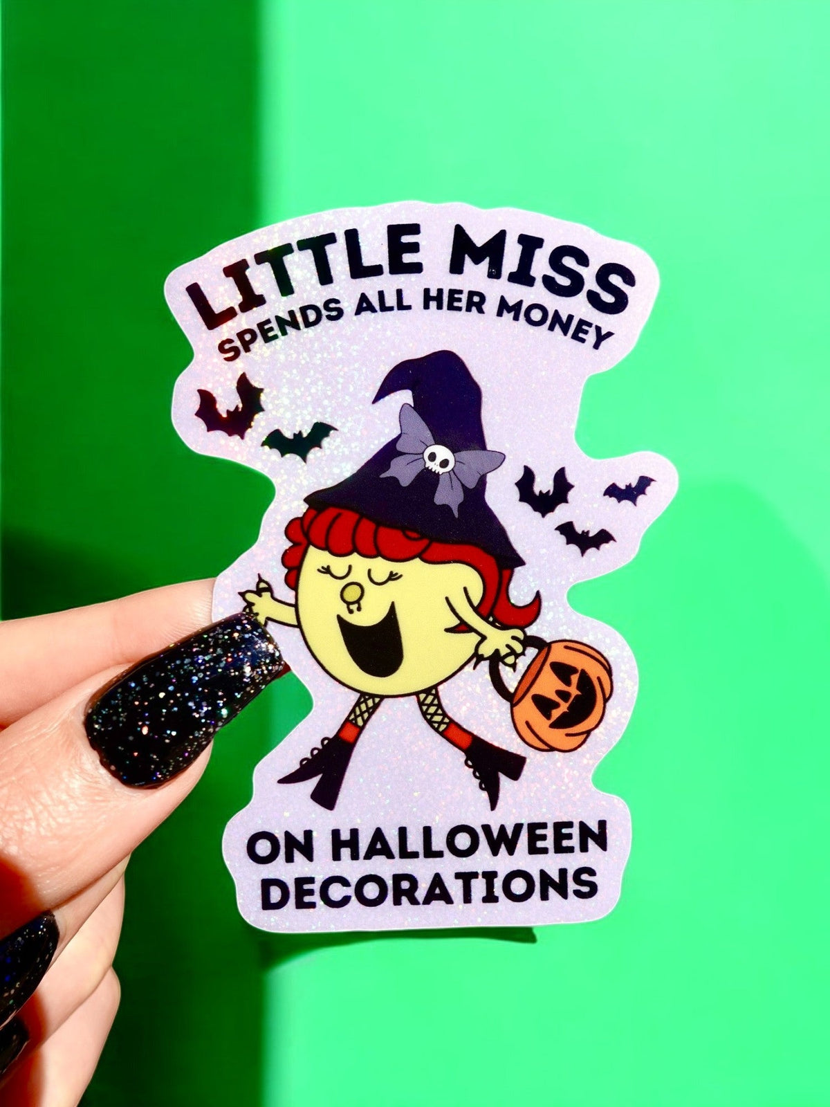 Funny Halloween sticker with witch girl holding jack-o'-lantern, bats, and text 'Little Miss'