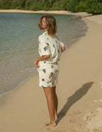 Elevated Faith Christian Shorts in cream with playful graphic designs, perfect for beach relaxation