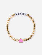 Elevated Faith Christian Jewelry Bracelet with gold beads and a pink heart charm that says LOVED