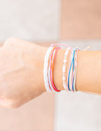 Colorful Elevated Faith Christian Jewelry Bracelet Stack on a Model's Wrist
