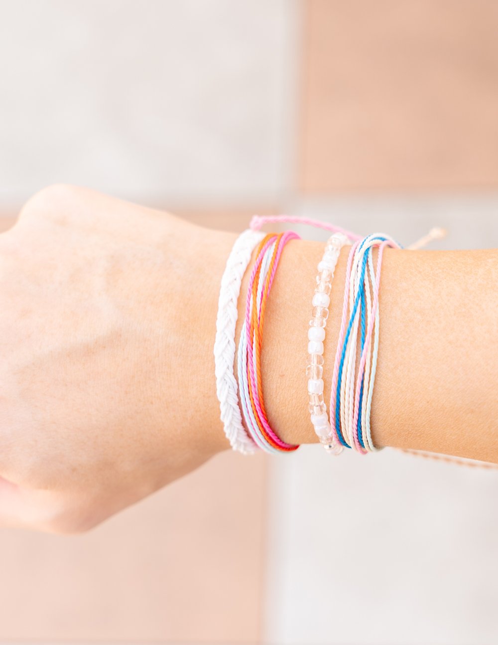 Colorful Elevated Faith Christian Jewelry Bracelet Stack on a Model's Wrist