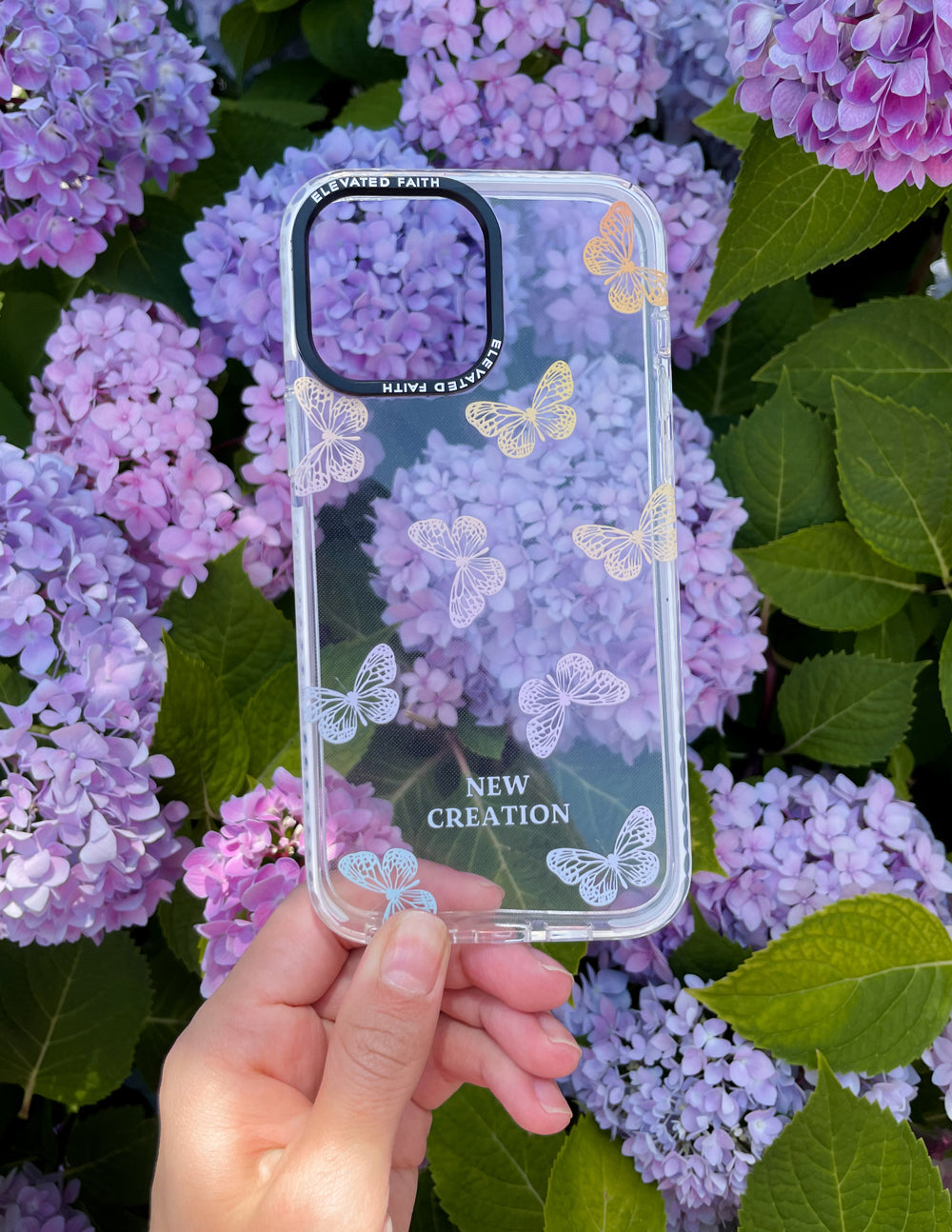 Clear Christian iPhone Case with colorful butterfly designs and 'New Creation' text