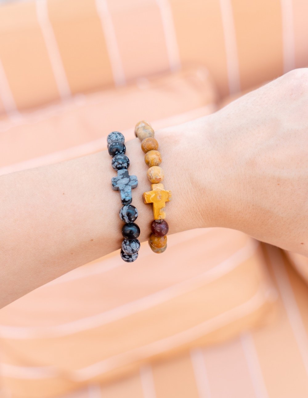 Hand wearing Elevated Faith Christian Jewelry Bracelet with colorful stone beads and crosses