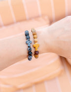 Hand wearing Elevated Faith Christian Jewelry Bracelet with colorful stone beads and crosses