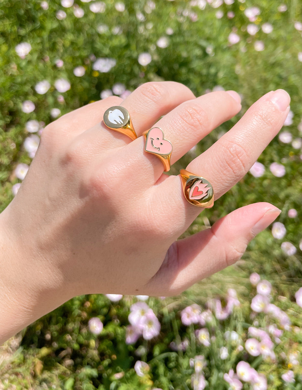 Three Elevated Faith rings in various designs, showcasing unique symbols of love as Christian Jewelry