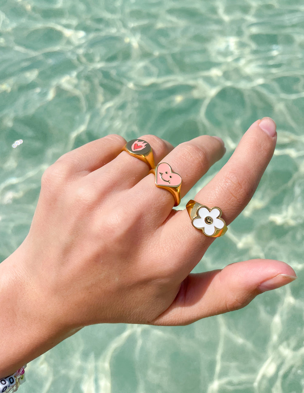 Three Gold Rings featuring Heart and Flower Designs, ideal Christian Jewelry for meaningful style