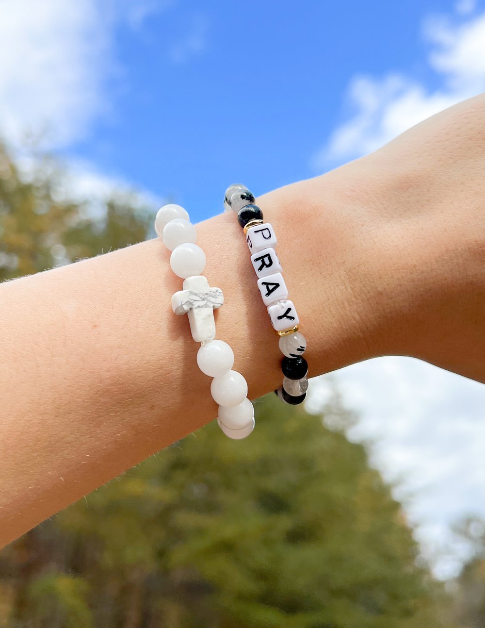 Elevated Faith Christian Jewelry Bracelet with letter beads spelling PRAY on a black and white design