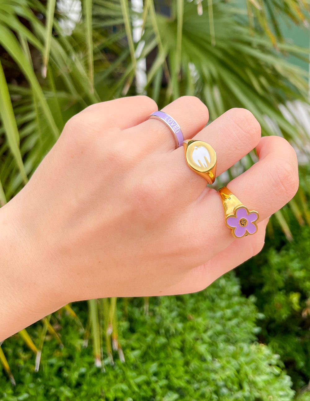 Two stylish rings on a hand featuring Elevated Faith Christian Jewelry with floral design