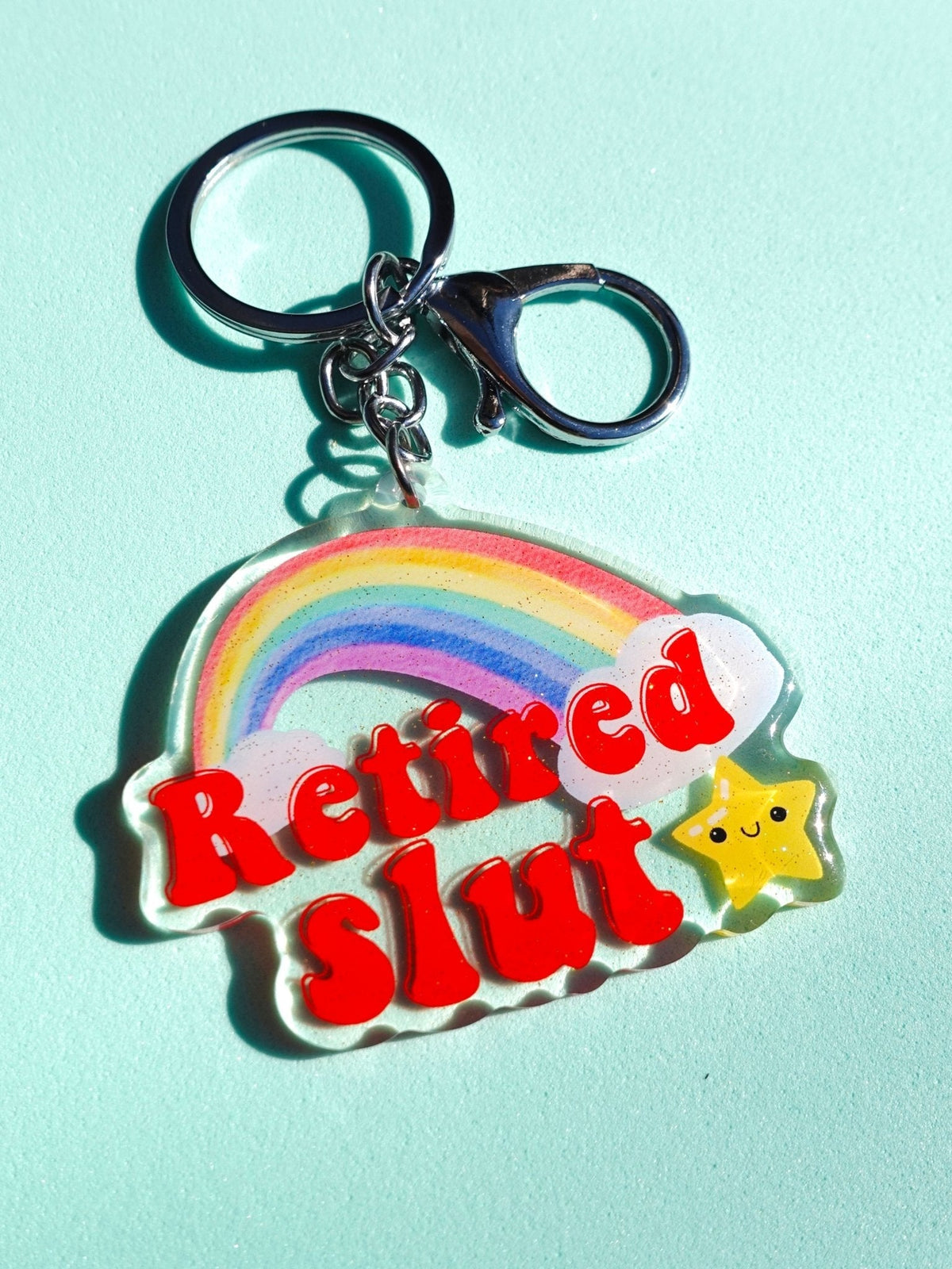 Funny Rainbow acrylic keychain: red 'Retired Slut' text and yellow star charm