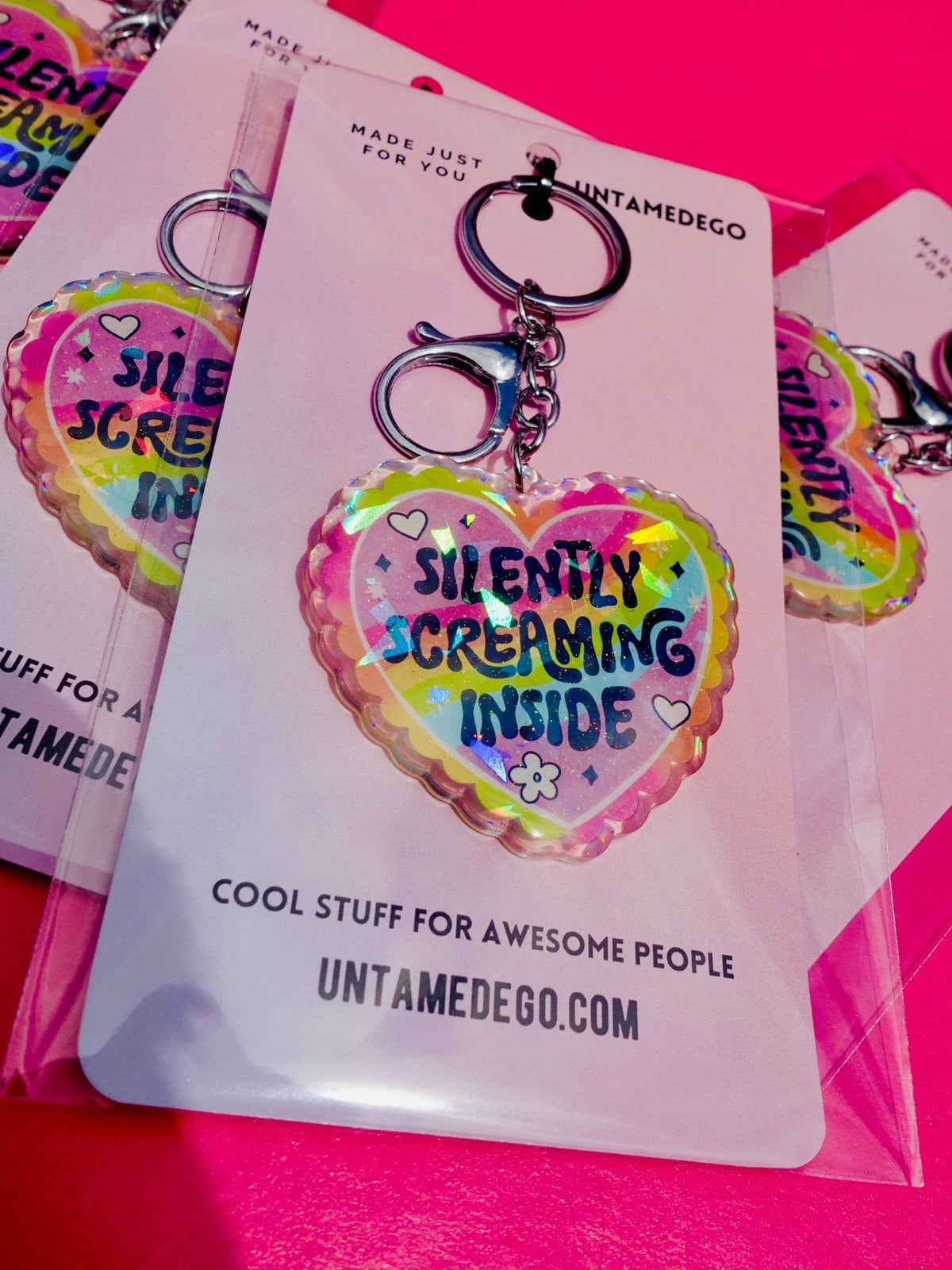 Funny Holographic heart keychain on a hang card with 'Silently Screaming Inside' text