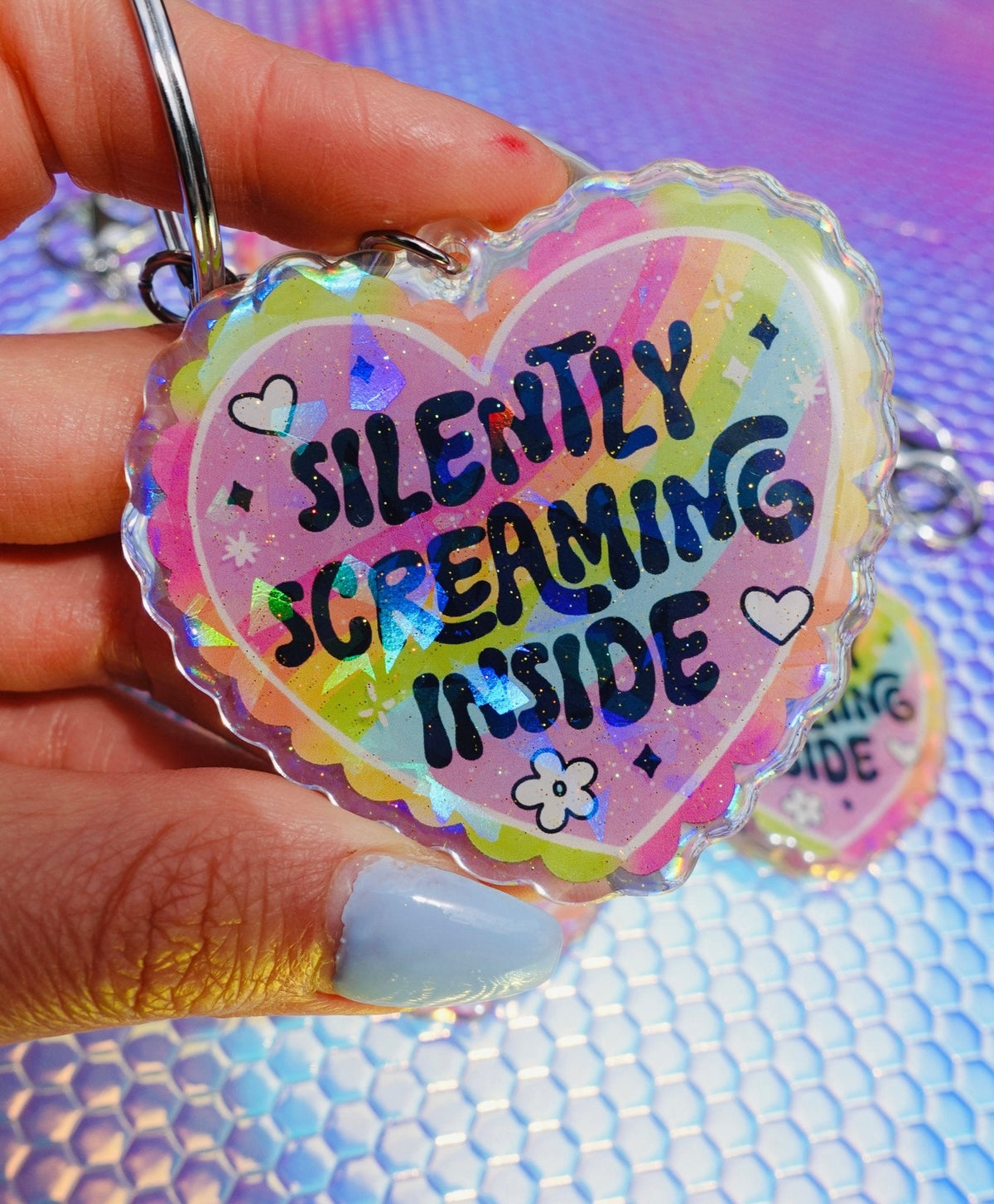 Funny Holographic heart keychain close-up with 'Silently Screaming Inside' rainbow lettering