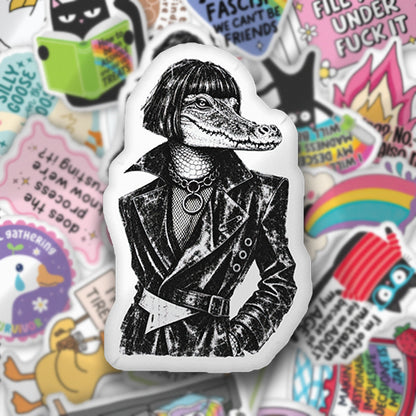 Custom-shaped graphic pillow with black-and-white reptile wearing a jacket
