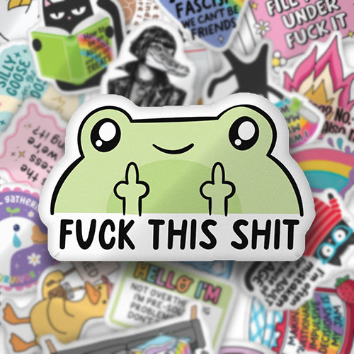 Custom-shaped green frog-face pillow with black eyes and 'FUCK THIS SHIT' print