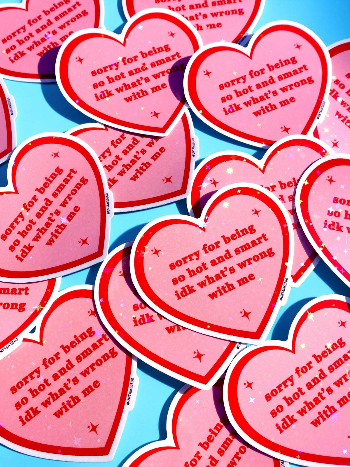 Funny Pile of heart-shaped red/pink stickers with white borders and starry text