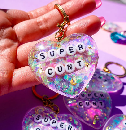 Funny Heart-shaped glitter keychain with gold clip, letter beads spelling SUPER and CUNT
