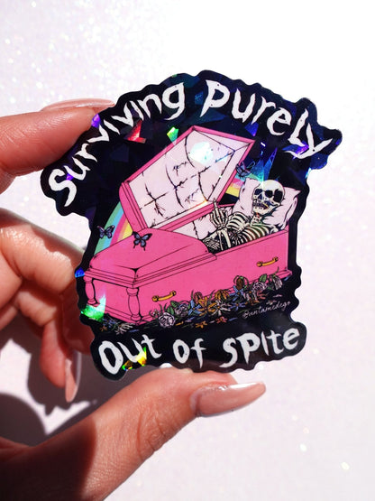Funny Black-and-pink gothic vinyl sticker: coffin and skeleton with 'Surviving Purely' and 'Out of Spite'.