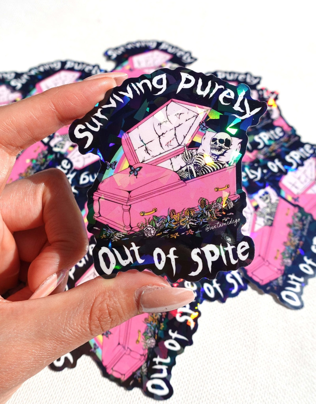 Funny Handheld set of gothic vinyl stickers with pink coffin, skeleton, and 'Surviving Purely'/'Out of Spite'.