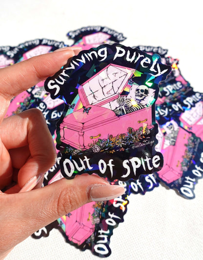 Funny Handheld set of gothic vinyl stickers with pink coffin, skeleton, and 'Surviving Purely'/'Out of Spite'.