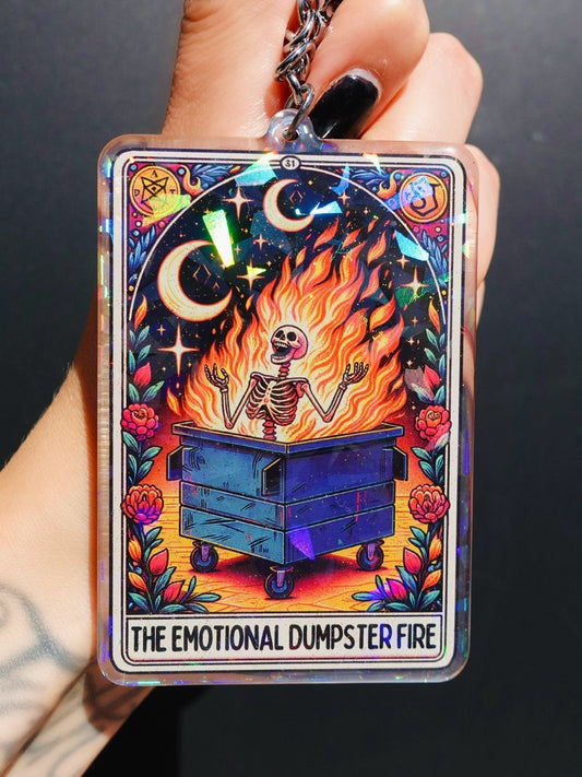 Funny Holographic keychain with fire face in dumpster illustration, flowers, and stars
