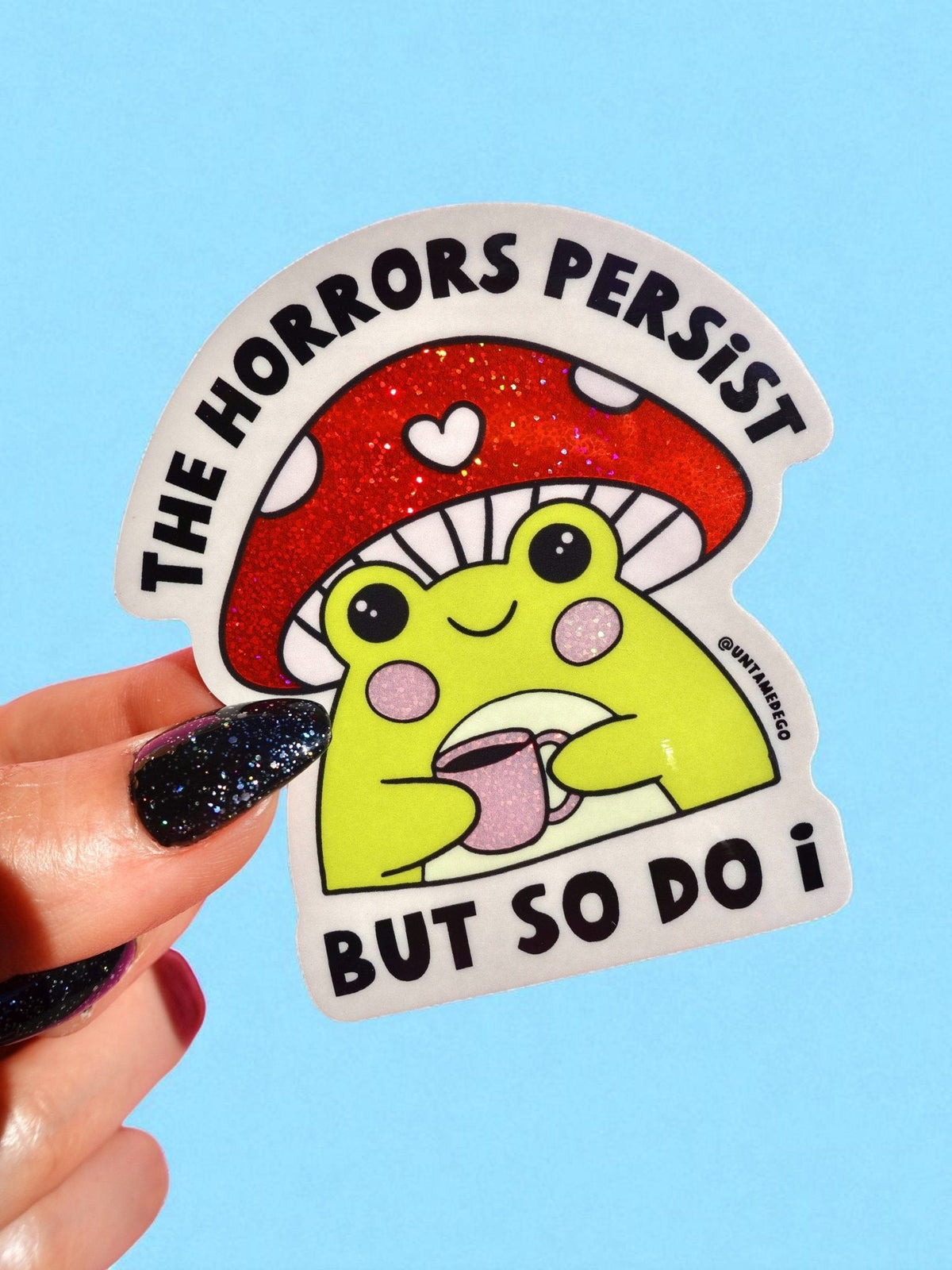 Funny Red glitter dinosaur sticker with heart, text: 'THE HORRORS PERSIST' 'BUT SO DO I'