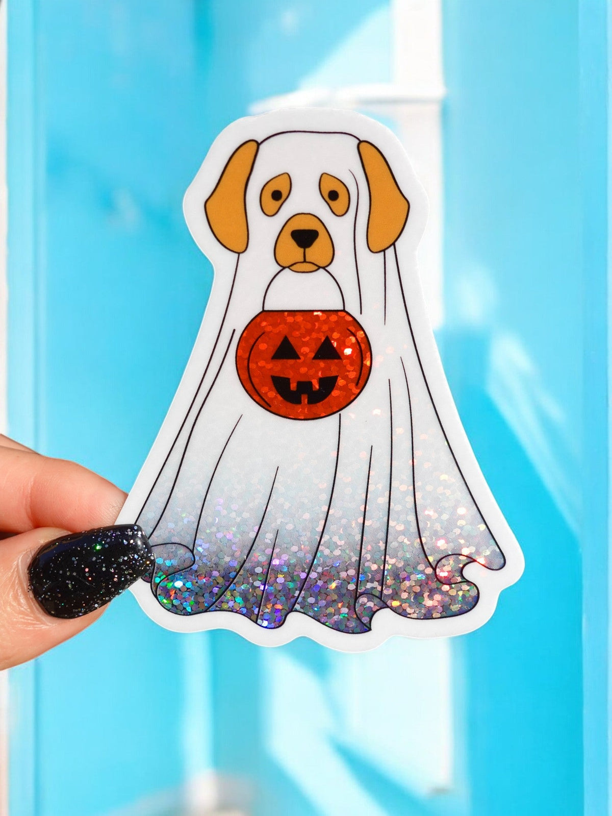 Funny Halloween dog sticker, white dog holding orange jack-o-lantern, glittery purple confetti bottom