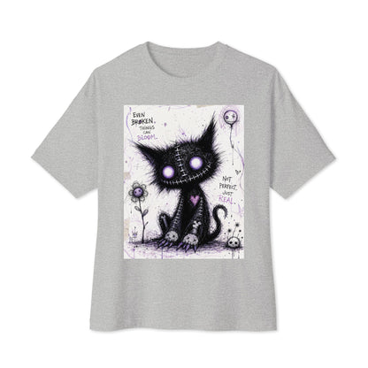 Athletic heather oversized boxy tee with the 'Even Broken Things Can Bloom' goth graphic: a stitched black cat with glowing purple eyes beside a flower, with the words "Even broken things can bloom"