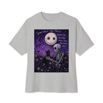 Athletic heather oversized boxy tee with the 'The Quiet Heals' goth graphic: a skeleton and a black cat in a purple flower field under a smiling moon, with the words "Sometimes the quiet holds me together more than anything else"