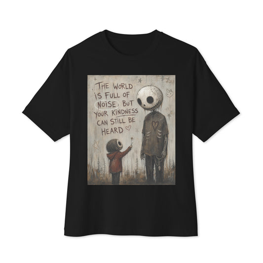 Black oversized boxy tee with the 'Stay Kind' goth graphic: a tall skull-faced figure and a small child holding a flower, with the words "The world is full of noise, but your kindness can still be heard"