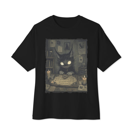 Black oversized boxy tee with the 'Free Readings' goth graphic: a wide-eyed black cat creature at a Ouija board surrounded by candles