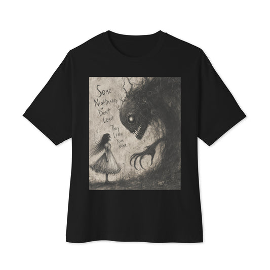 Black oversized boxy tee with the 'Nightmares' goth graphic: a girl in a white dress facing a shadowy clawed monster, with the words "Some nightmares don't leave, they learn your name"