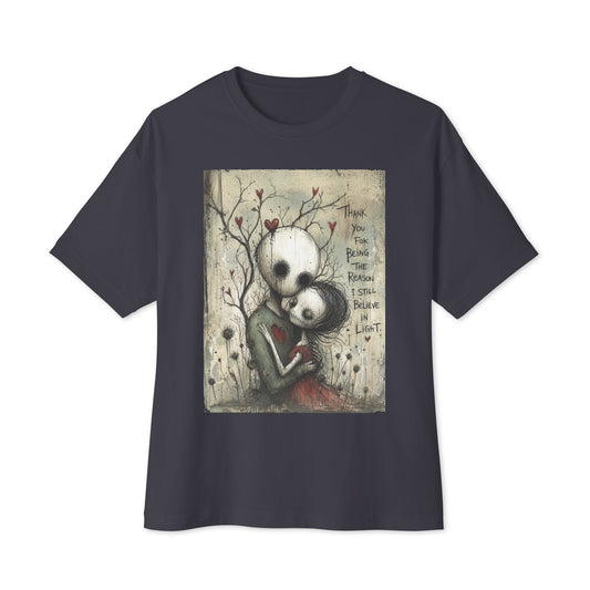 Dark grey oversized boxy tee with the 'My Light In Dark Places' goth graphic: a skull-faced couple embracing under a bare tree with red hearts, with the words "Thank you for being the reason I still believe in light"