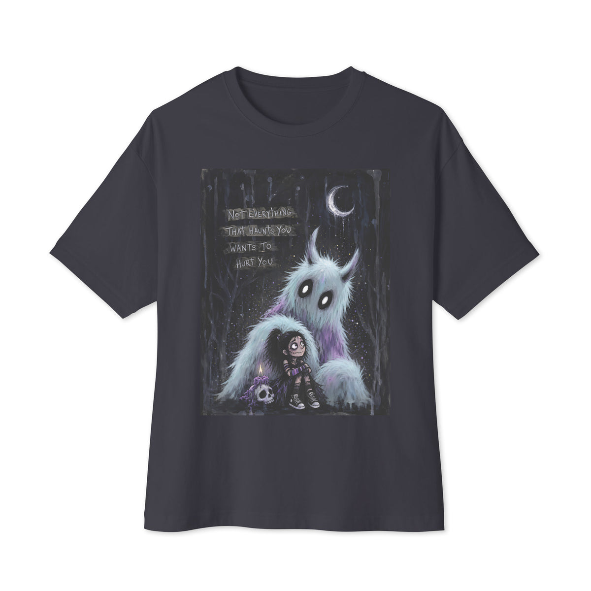 Dark grey oversized boxy tee with the 'The Haunted' goth graphic: a little goth girl holding a candle beside a fuzzy blue monster under a crescent moon, with the words "Not everything that haunts you wants to hurt you"