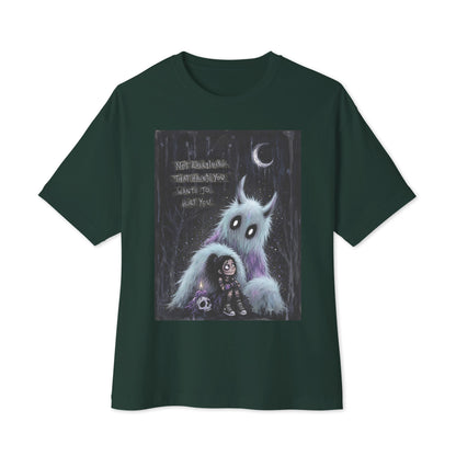 Forest oversized boxy tee with the 'The Haunted' goth graphic: a little goth girl holding a candle beside a fuzzy blue monster under a crescent moon, with the words "Not everything that haunts you wants to hurt you"